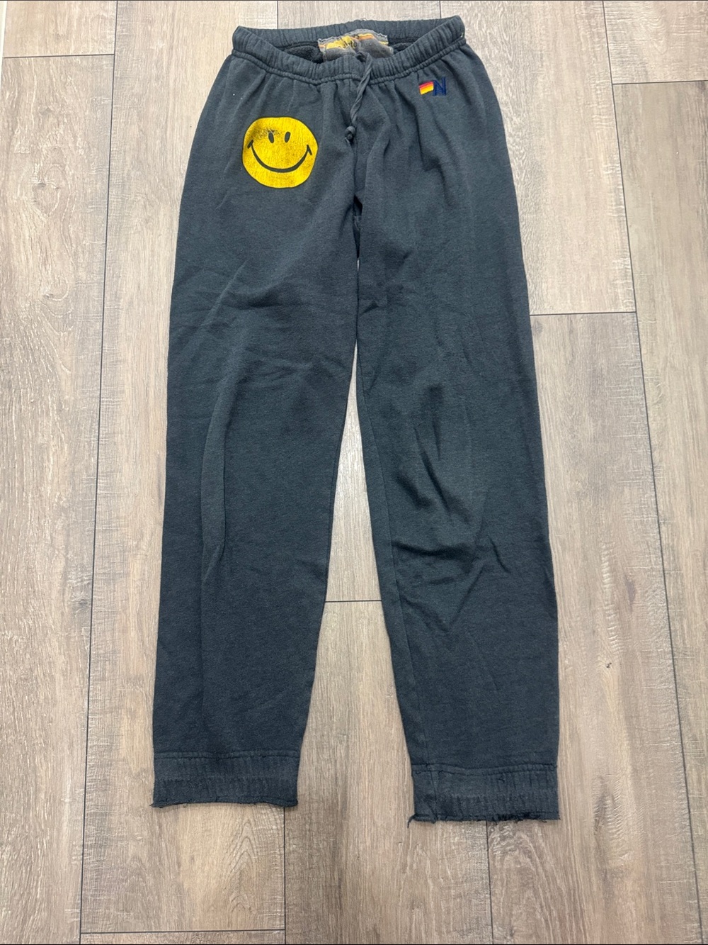 Women’s charcoal grey Aviator Nation Sweatpants with Yellow Smiley Graphic